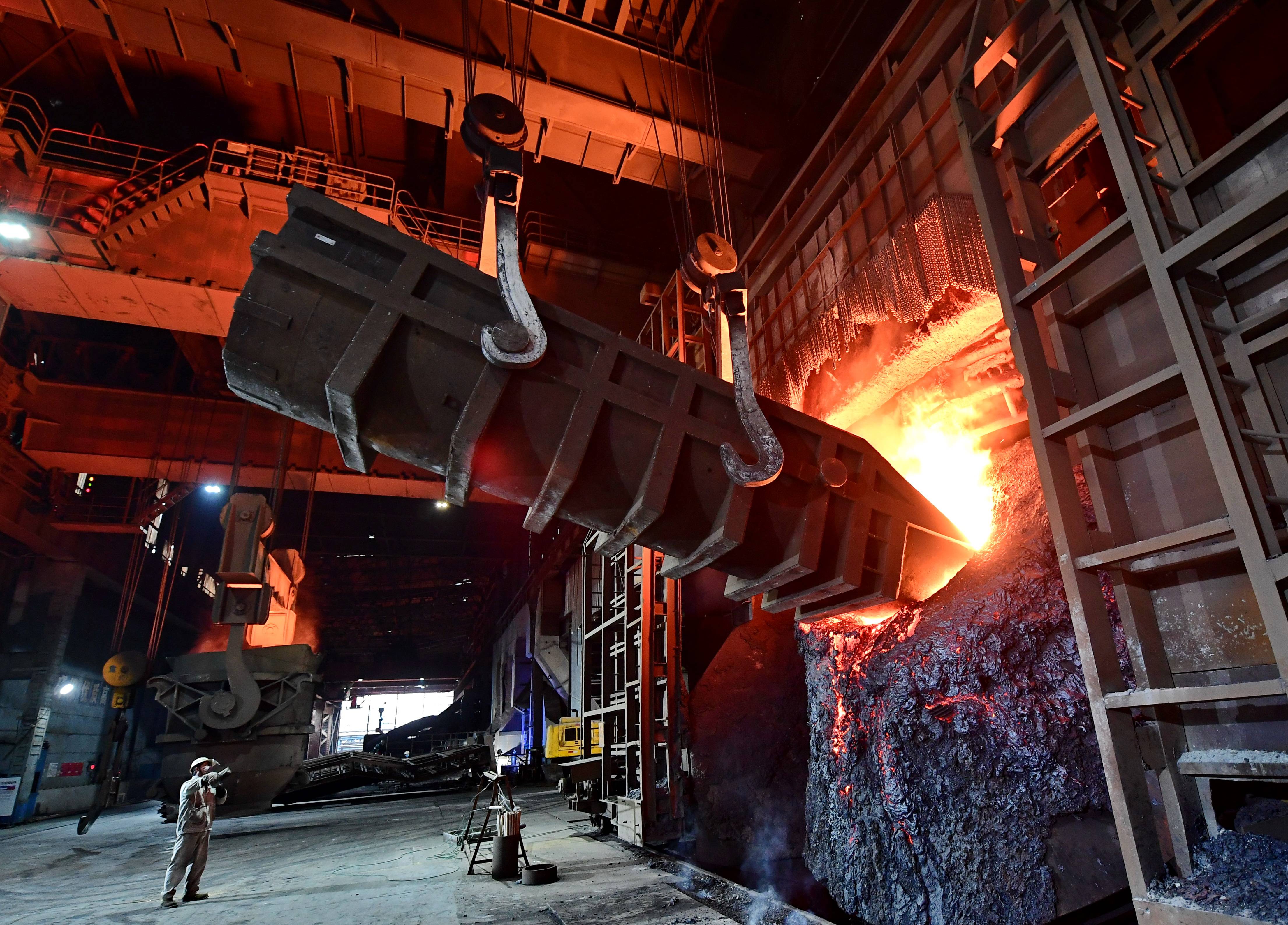 工人在唐山市丰润区一家钢铁企业炼钢炉前工作.