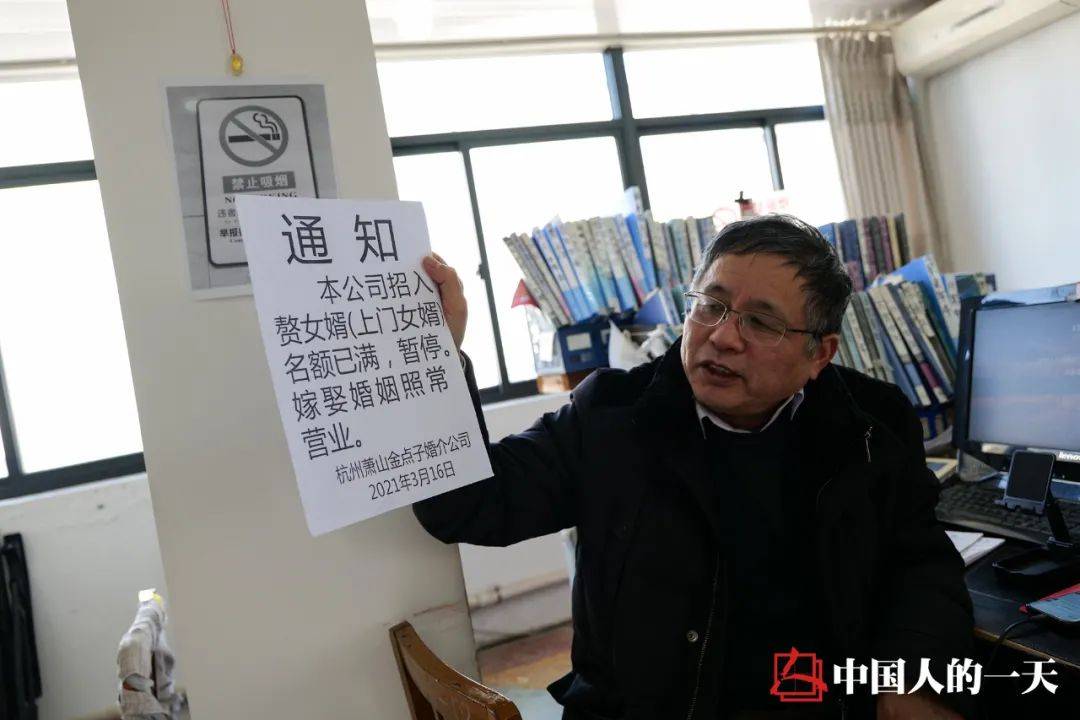 李继延向前来咨询的客人展示"名额已满"的通知.