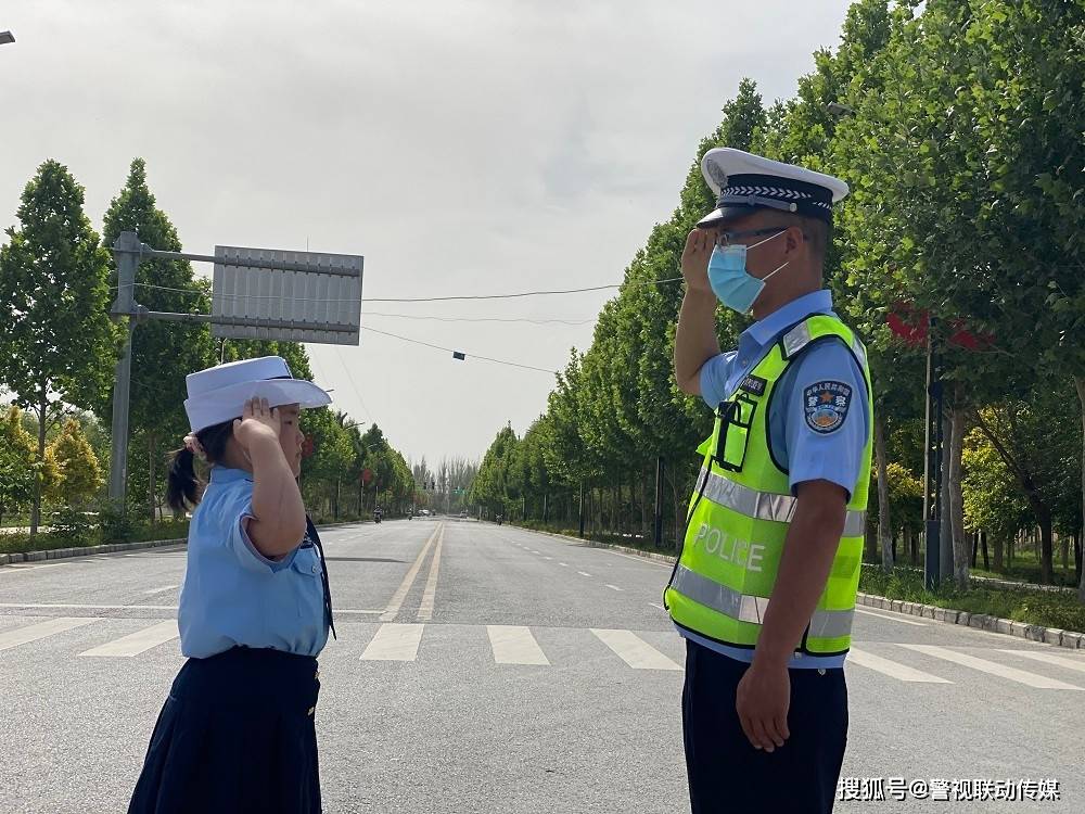 交警组李维海与女儿的敬礼照片很是温馨,呈现了一道靓丽风景.