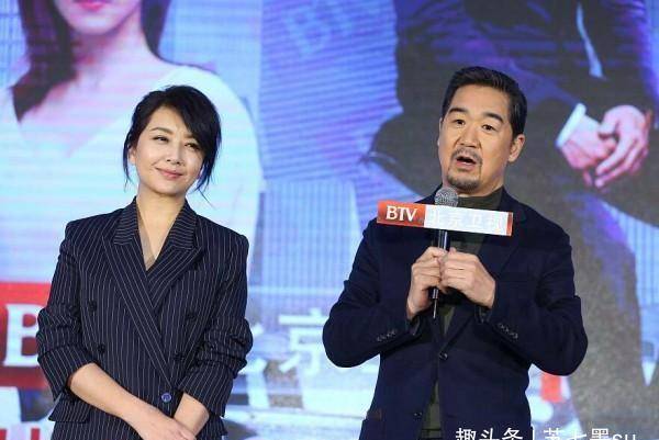 这是江珊和张国立一起出席活动时候的穿搭,是深灰色条纹的西装套装,也