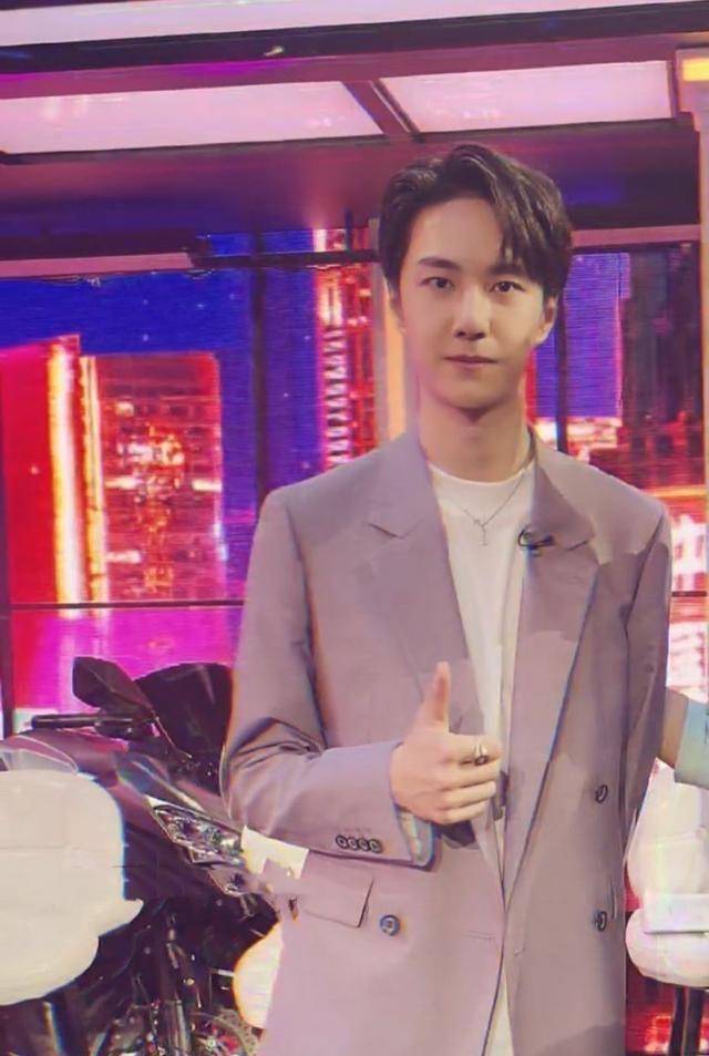 王一博骑着摩托车录制《跨年综艺》,一身粉色西装现身,后台人争相合影