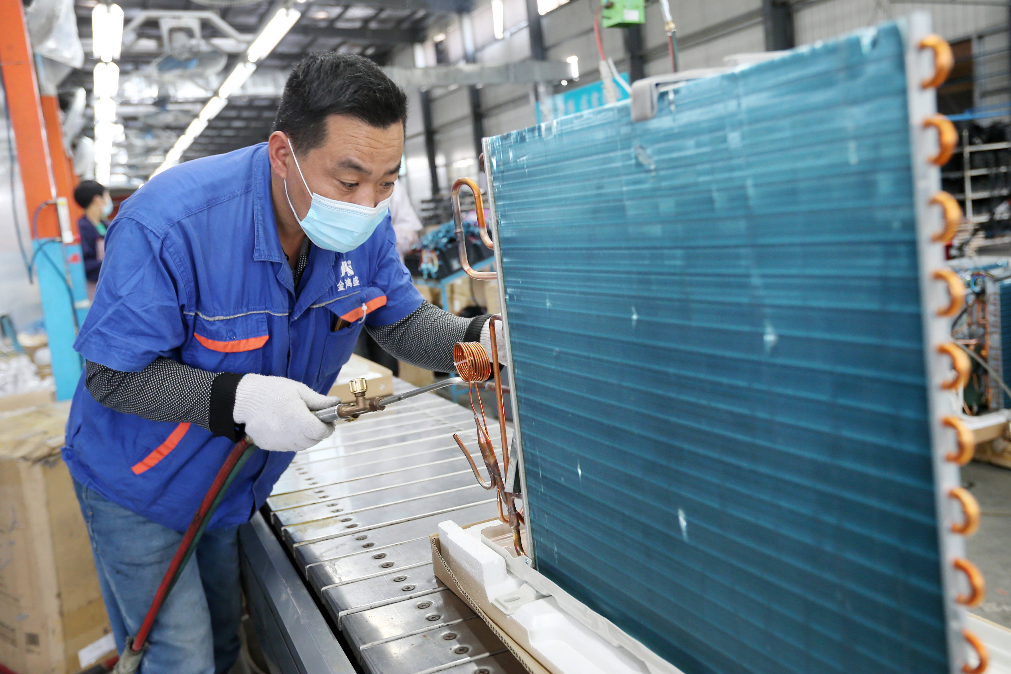 5月18日,工人在淮北市濉溪经济开发区一家空调企业车间内忙碌.