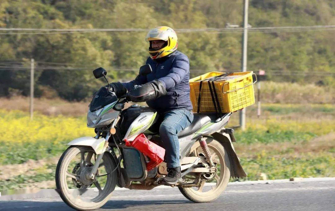 1月9日,在209国道广西柳州市融安县浮石镇路段,务工人员骑摩托车回家